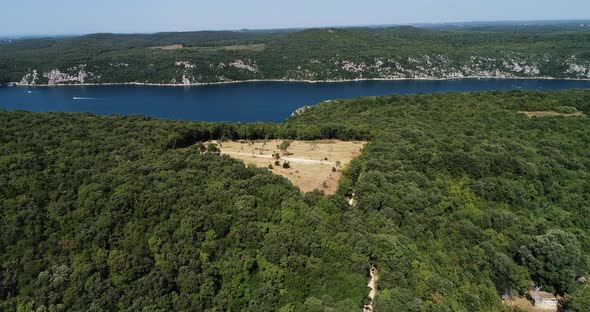 Aerial view of a deforested field along the lake near Lastovo, Croatia. alt