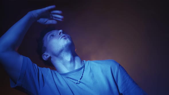 Portrait Stylish Male Dancer Performs a Dance in Neon Lighting alt