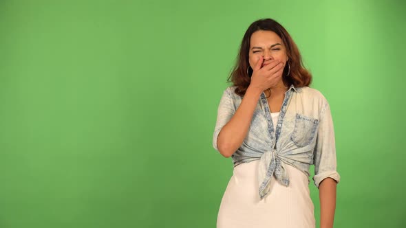 A Young Beautiful Caucasian Woman Yawns  Green Screen Background