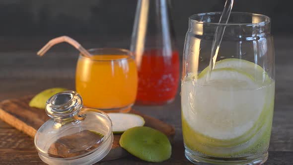 Preparation of Homemade Lemonade From Citrus Fruits Against the Background of Various Drinks