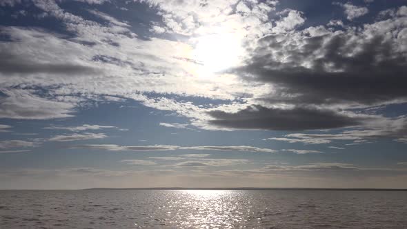 Bright Neat Cloud Fragments Above the Lake alt