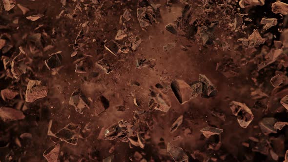 Super Slow Motion Shot of Raw Chocolate Chunks and Cocoa Powder after Being Exploded at 1000fps. alt