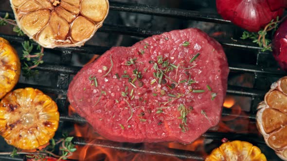 Super Slow Motion Top Shot of Fresh Beef Meat and Seasoning Falling on Grill at 1000 Fps alt