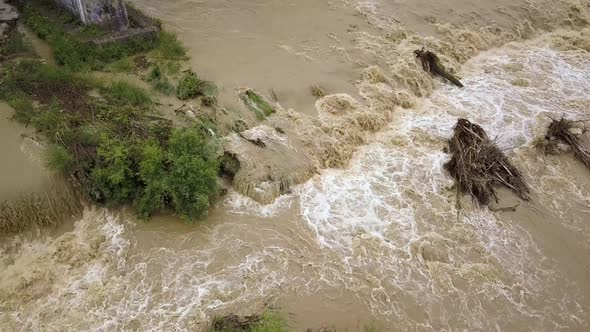 Aerial view of wide dirty river with muddy water in flooding period during heavy rains in spring. alt