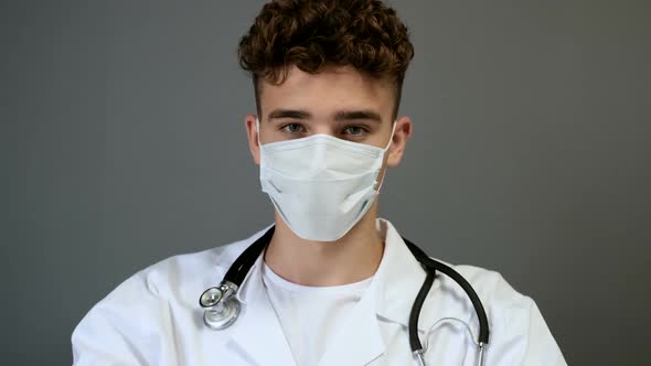 Medical Student  Intern in medical mask, who is looking at the camera and wear protective glasses