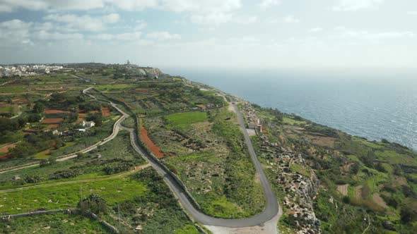 AERIAL: Dingli Cliffs with Lone Hill Road near Mediterranean Sea on a Sunny Day in Winter
