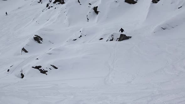 A man skiing and jumping on a snow covered mountain alt