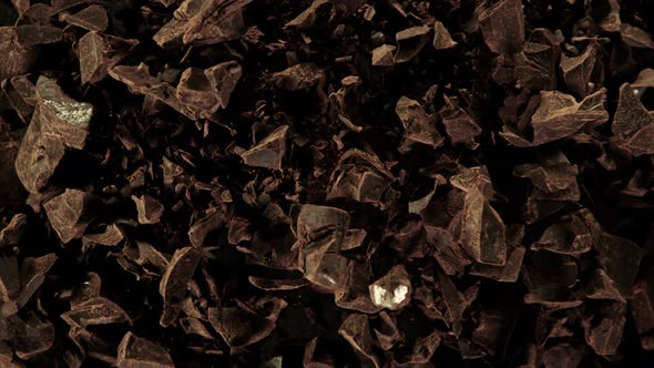 Super Slow Motion Shot of Raw Chocolate Chunks and Cocoa Powder After Being Exploded at 1000Fps. alt