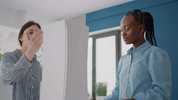 Close Up of Colleagues Looking at Building Model and Maquette to Plan Layout Details alt