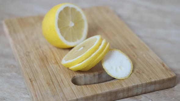 Sliced lemon on a wooden board. alt