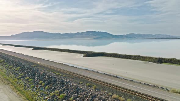 AERIAL - Mountain range and railroad tracks, Great Salt Lake, Utah, truck right alt