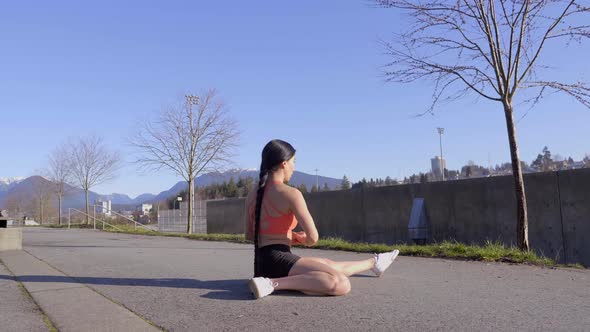 Young flexible athletic woman doing side split squat exercise alt