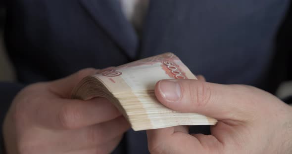 Male Hands Counting Money. Russian Money Banknotes of 5,000 Rubles