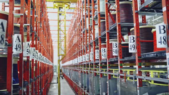 Modern cable factory. Cable warehouse interior with shelves alt