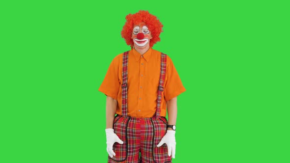 Funny Clown Looking at Watch and Running Away Being Late on a Green Screen, Chroma Key. alt