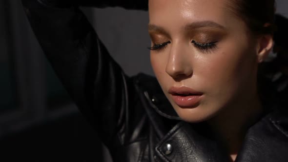 Young Model with Hair and Big Brown Eyes, Standing in the Old City Quarter, Wind Plays with Her Hair alt