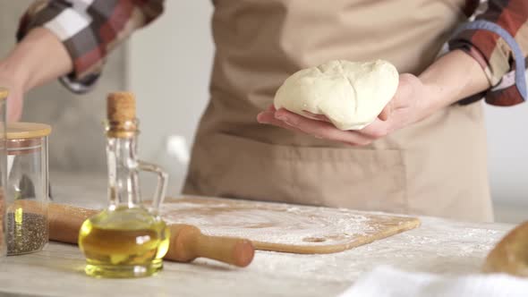 Chewing The Dough. Professional Chef Kneads The Dough alt
