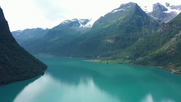Wide panoramic view over stunning Oldedalen valley with glaciers on mountaintops and emerald green f alt
