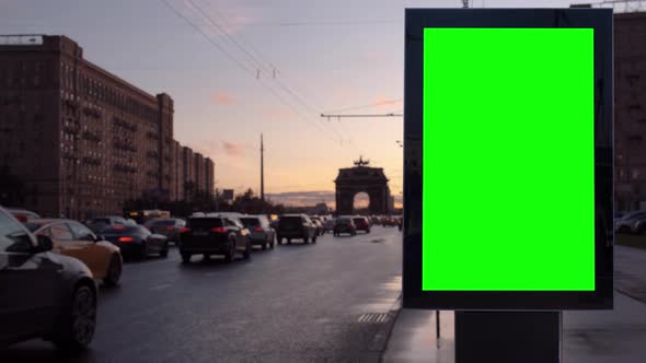 Green Screen Blank Billboard on a Busy Street Against Sunset alt