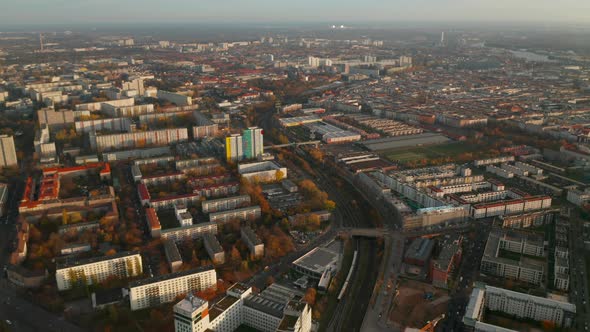 View of City From Above with Train Passing Through Urban Area with Apartment Buildings in Autumn alt