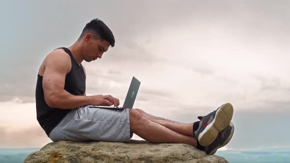 Handsome Man Work on Laptop on Mountain on Background Amazing Natural Location alt