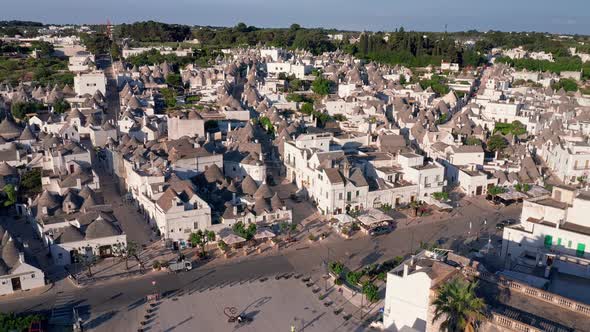 Aerial view of trulli of alberobello town in Italy. drone fly over old town buildings at sunrise