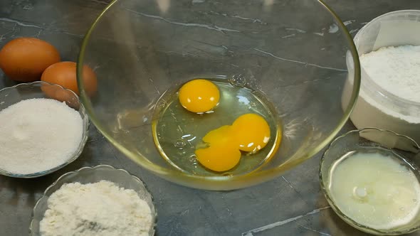 Female Hand Crack Eggs Into Glass Mixing Bowl Homemade Dough Cake Bakery Concept