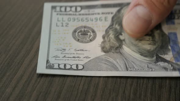 Counting American currency close-up 4K 2160p 30fps UltraHD footage - USA dollar banknotes  on table  alt