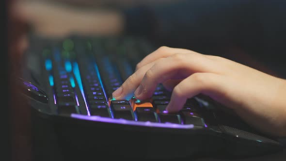Close Up Young Gamer Hands Pushing Buttons on Keyboards, Working, Betting, Playing. alt