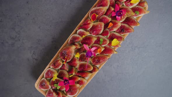 Biscuit with Fig Slices Flowers and Colorful Leaves on Top alt