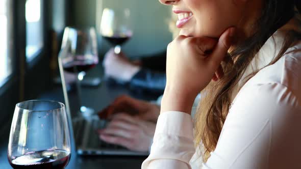 Beautiful woman holding glass of wine in restaurant alt