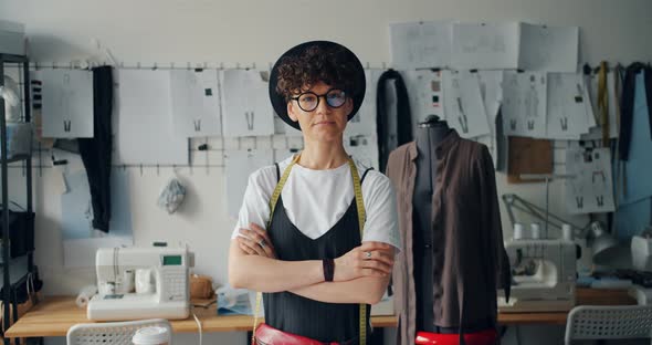 Portrait of Independent Woman Designer Standing in Studio with Arms Crossed alt