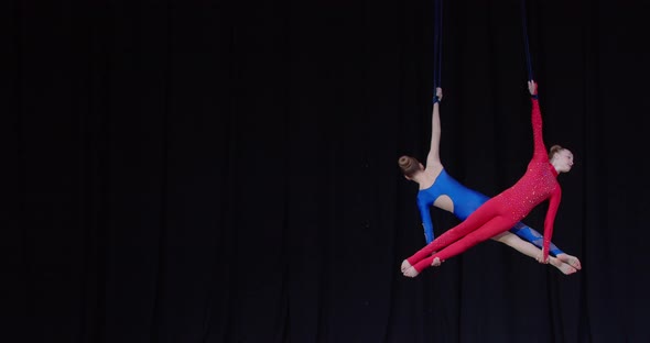 Tournament of Aerial Gymnastics on Stage Two Girls are Spinning Sports alt