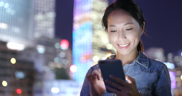 Woman use of smart phone in city at night  alt
