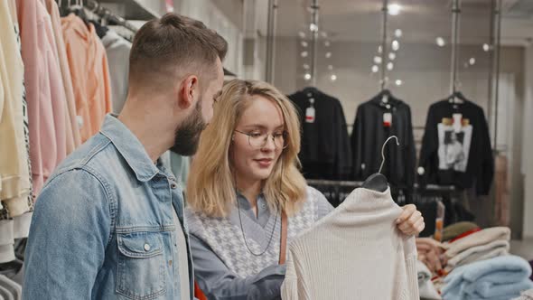 Stylish Couple Doing Shopping At Clothing Store alt