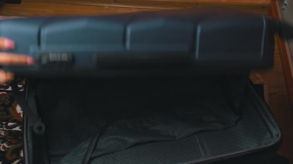 Girl Collects Clothes in a Suitcase alt