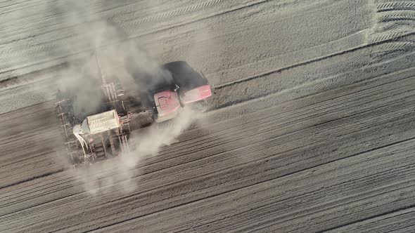 Countryside and Agriculture, Farm Tractors Plow the Earth in Field, Dust in the Field, View From alt