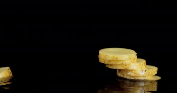 Round Slices of Potatoes Fall on the Water with Splashes.  alt