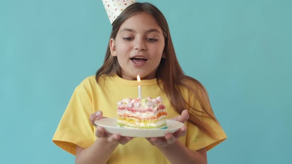 Girl Blowing out Candle on Cake alt