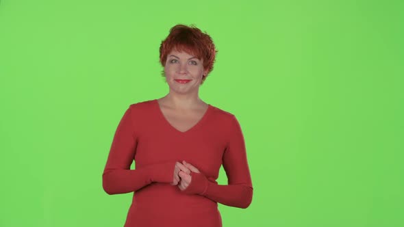 Redhaired Woman Advertises the Products and Shows a Thumbs Up. Green Screen alt