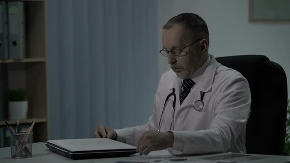 Senior Experienced Physician Exhausted After Day Shift at Hospital, Overworking alt