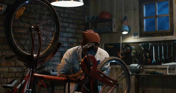 Man Working in a Bicycle Repair Shop alt