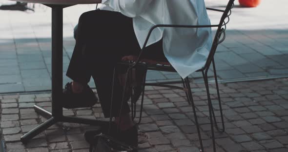 Two women sit at table working alt
