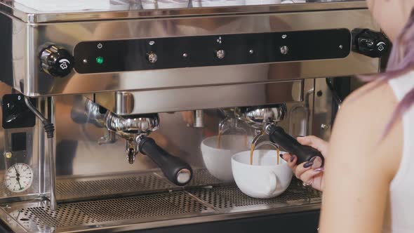 Crop View of Female Barista Frothing Milk in Metal Pitcher with Coffee Machine