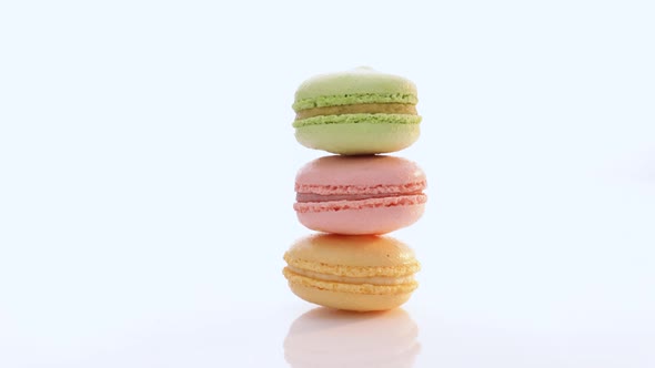 Vertical Stack of Three Macarons Against a Bright White Background