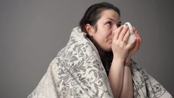 Portrait of Sick Tired Woman Patient with White Cup Sitting on Sofa