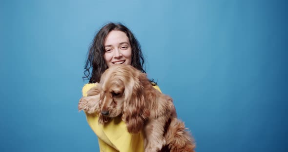 English Cocker Spaniel with a Sunglasses Posing with a Woman in Studio alt