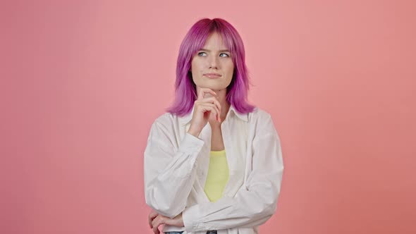 Young Pinkhaired Woman Looks Thoughtful in Pink Studio alt