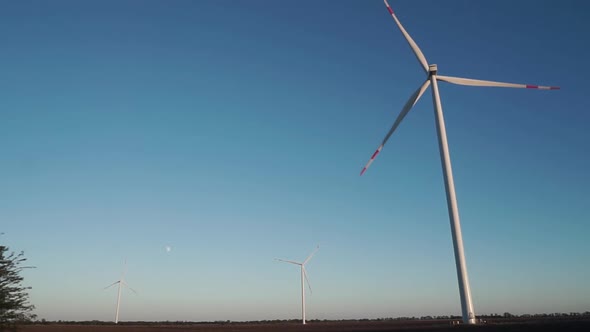 Three Wind Turbines are Operating at Full Capacity Around the Clock in the Field
