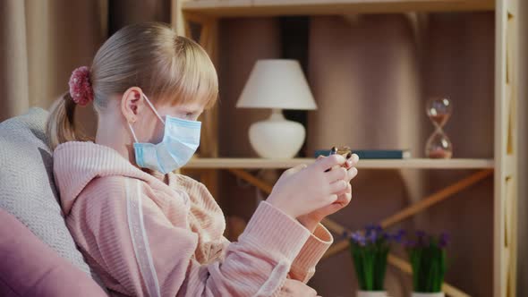 A Child in His Room Playing on a Smartphone alt